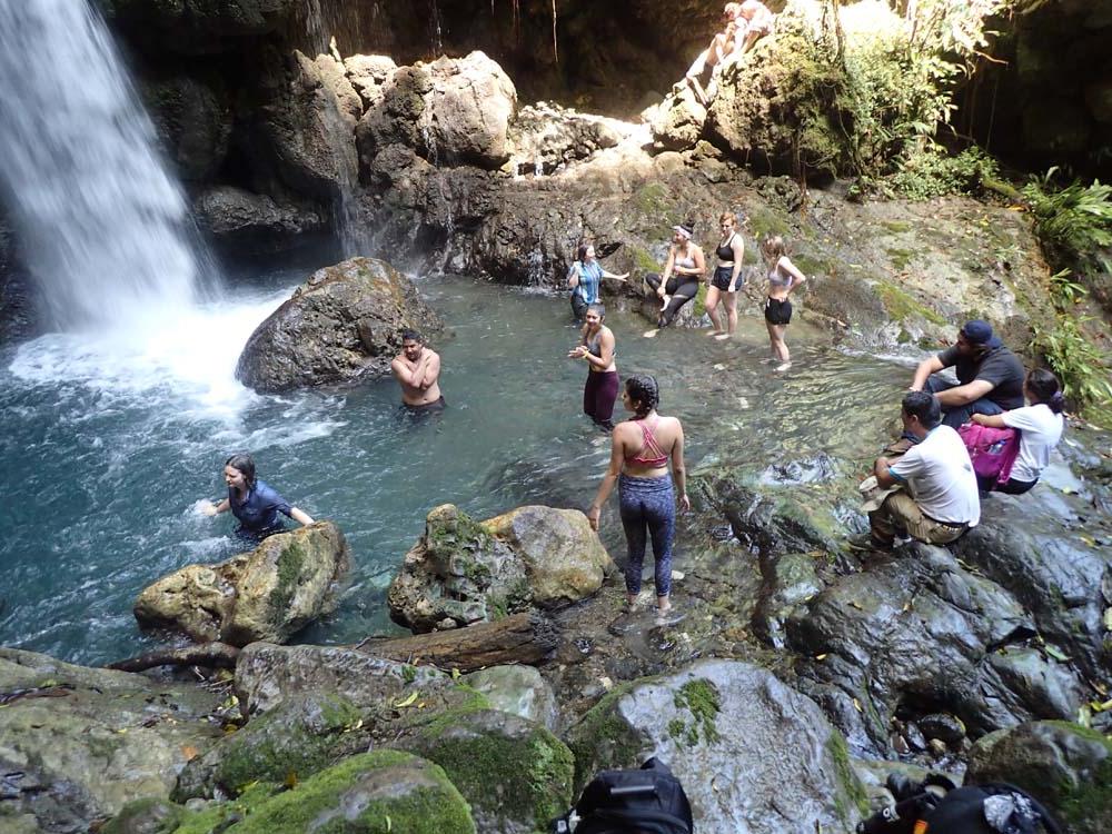 Image of students in peru exploring one of the waterfalls